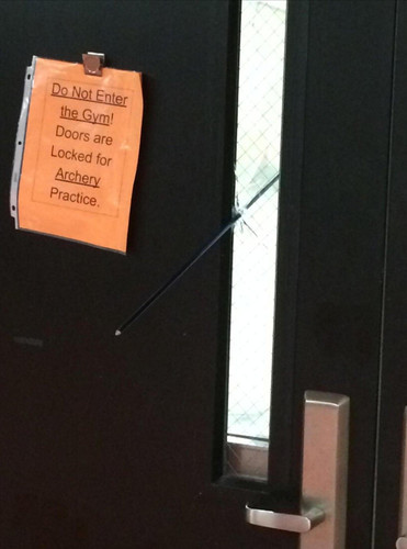 Do not enter the gym! Doors are Locked for Archery Practice. (Перевод: Не входите в зал, идёт тренировка лучников)